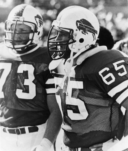 black and white photo of tim and terry vogler in football uniforms