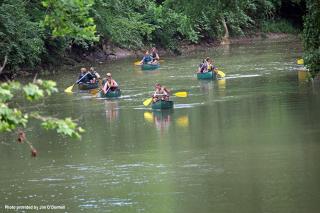 people kayaking and canoeing on a river